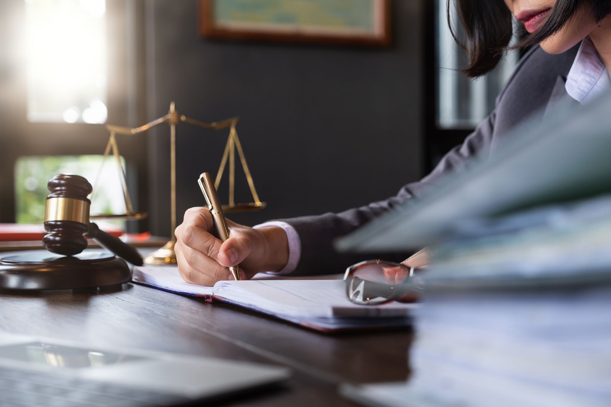 Female lawyer working on a labour lawsuit at her office desk.